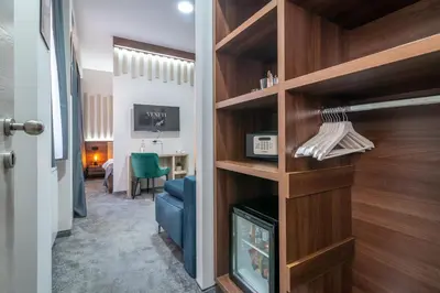 a living room with a fireplace and a blue couch at Veneti Suites in Belgrade