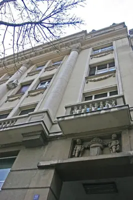 a tall building with a balcony on top of it at Broz Apartment in Belgrade