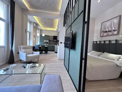 a living room with a bed and a couch at Broz Apartment in Belgrade
