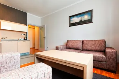 a living room with a couch and a table at Garni Hotel Nevski in Belgrade