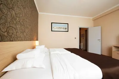 a bedroom with a large bed with white pillows at Garni Hotel Nevski in Belgrade