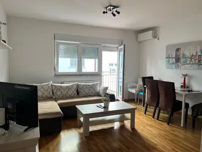 a living room with a couch and a table at Apartment Leonis in Belgrade