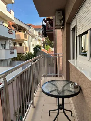 a balcony with a glass table on a balcony at Apartment Leonis in Belgrade