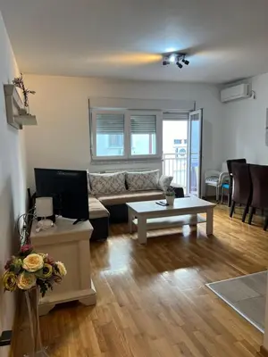 a living room with a couch and a table at Apartment Leonis in Belgrade