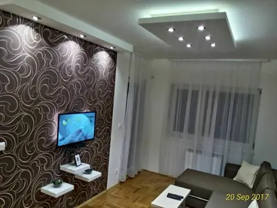 a living room with a tv on a wall at Apartment Frida in Belgrade