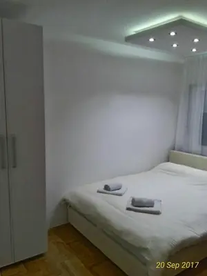 a bedroom with a bed with two towels on it at Apartment Frida in Belgrade