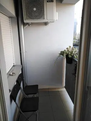 a small room with a chair and a microwave at Apartment Frida in Belgrade
