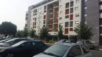 a parking lot with cars parked in front of a building at Apartment Frida in Belgrade