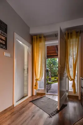 an open door with yellow curtains in a room at Aerport - Natura Apartment in Belgrade
