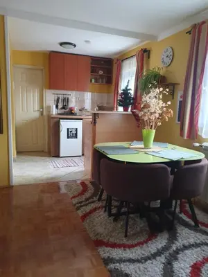 a kitchen and dining room with a table and chairs at Aerport - Natura Apartment in Belgrade