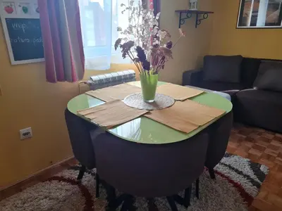 a table with a vase of flowers on top of it at Aerport - Natura Apartment in Belgrade