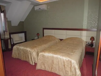 a hotel room with two beds in a room at Hotel Sucevic Garni in Belgrade