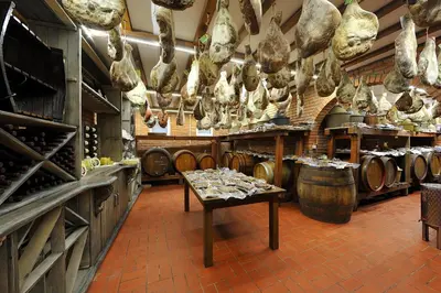 a store with a bunch of meat hanging from the ceiling at Hotel Sucevic Garni in Belgrade