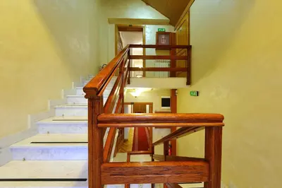 a wooden staircase in a house with a stair case at Hotel Sucevic Garni in Belgrade