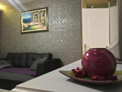 a living room with a purple vase on a table at Apartment Milos in Belgrade