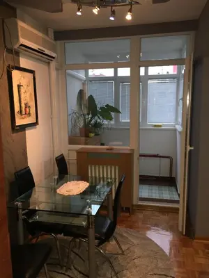 a dining room with a glass table and chairs at Apartment Milos in Belgrade