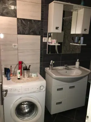 a bathroom with a washing machine and a sink at Apartment Milos in Belgrade