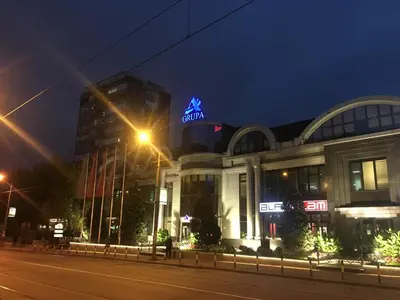 a building with a neon sign in front of it at Apartment Milos in Belgrade