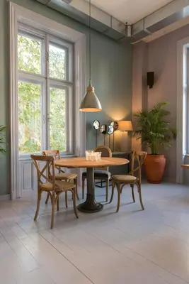 a dining room with a wooden table and chairs at Smokvica Dorćol B&B in Belgrade