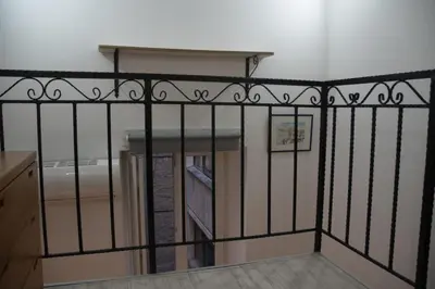 a black iron fence with a staircase in a room at Double Decker Apartment in Belgrade