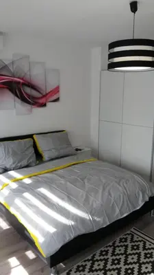 a bedroom with a bed and a painting on the wall at White City 1 Apartment in Belgrade