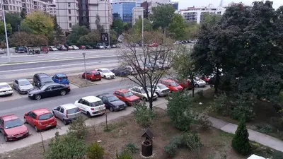 a bunch of cars parked in a parking lot at White City 1 Apartment in Belgrade