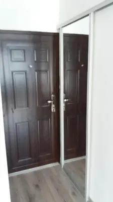 a mirror in a room with two doors at White City 1 Apartment in Belgrade