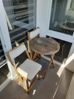a table and a chair and a table and a table and a table at White City 1 Apartment in Belgrade