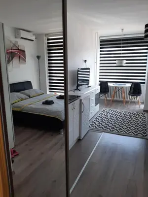 a living room with a bed and a mirror at White City 1 Apartment in Belgrade