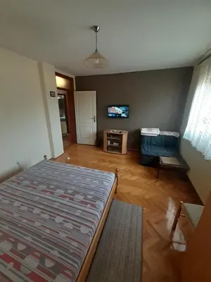 a bedroom with a bed and a tv on a wall at Apartman Stankovic in Arandjelovac