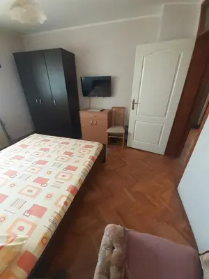 a small bedroom with a bed and a tv at Apartman Stankovic in Arandjelovac