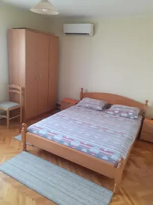 a small bedroom with a bed and a cabinet at Apartman Stankovic in Arandjelovac