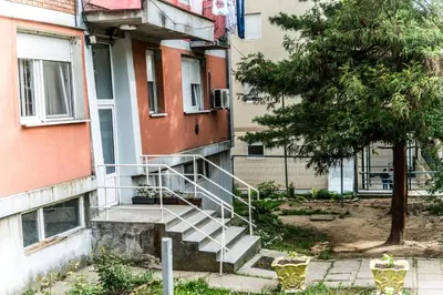 a staircase leading to a building with a tree at Apartman Stankovic in Arandjelovac
