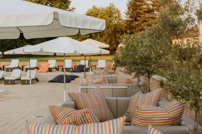 a group of chairs and umbrellas on a patio at Hotel 1000 Ruza in Belgrade