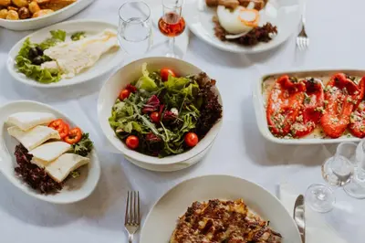 a white table with plates of food on it at Hotel 1000 Ruza in Belgrade
