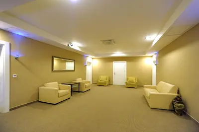 a waiting room with couches and a table and lights at Hotel 1000 Ruza in Belgrade