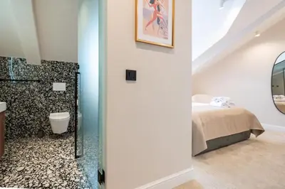 a bathroom with a shower and a bed in a room at Boem Exclusive Rooms Skadarlija in Belgrade