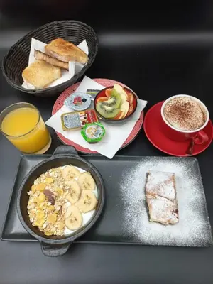 a table with a tray of breakfast foods and coffee at Boem Exclusive Rooms Skadarlija in Belgrade