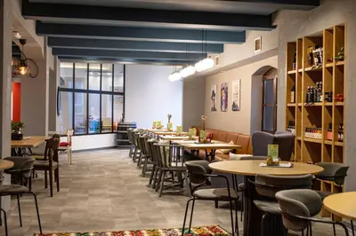 a row of tables and chairs in a restaurant at Boem Exclusive Rooms Skadarlija in Belgrade