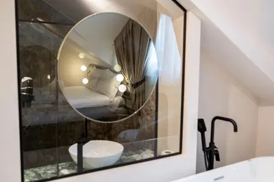 a bathroom with a mirror and a sink at Boem Exclusive Rooms Skadarlija in Belgrade