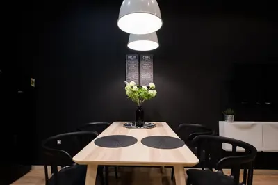 a table with a vase of flowers on it at Lella Apartment 2 - duplex - epicenter of Belgrade in Belgrade
