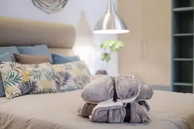 a stuffed elephant sitting on top of a bed at Lella Apartment 2 - duplex - epicenter of Belgrade in Belgrade