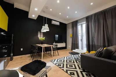 a living room with a couch and a table at Lella Apartment 2 - duplex - epicenter of Belgrade in Belgrade