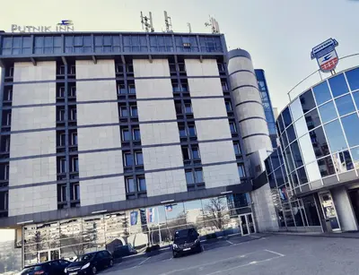 a building with cars parked in front of it at Putnik Inn Belgrade in Belgrade