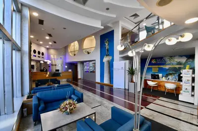 a lobby with blue couches and a waiting room at Putnik Inn Belgrade in Belgrade