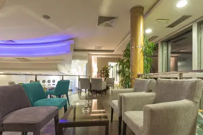 a restaurant with chairs and tables and a bar at Putnik Inn Belgrade in Belgrade