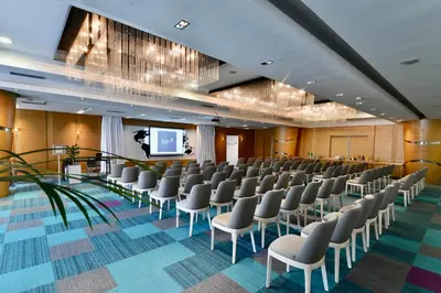 a conference room with chairs and a projection screen at Putnik Inn Belgrade in Belgrade