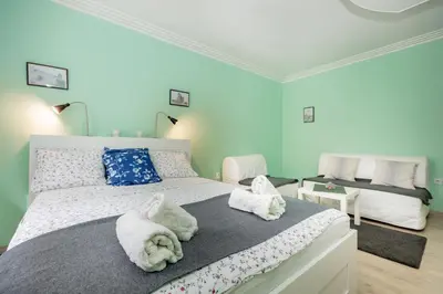 a bedroom with a bed with towels on it at Apartman Gloria 2 in Belgrade