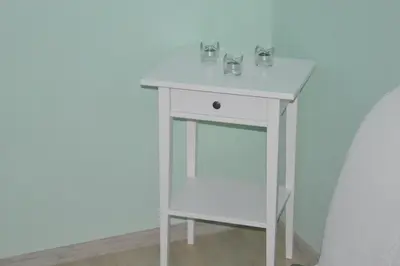 a white table with two glasses on top of it at Apartman Gloria 2 in Belgrade