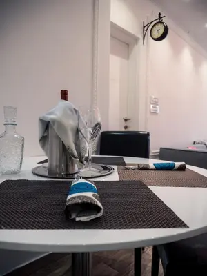 a table with a napkin and a glass on it at Centrally Located Relaxing Place in Belgrade